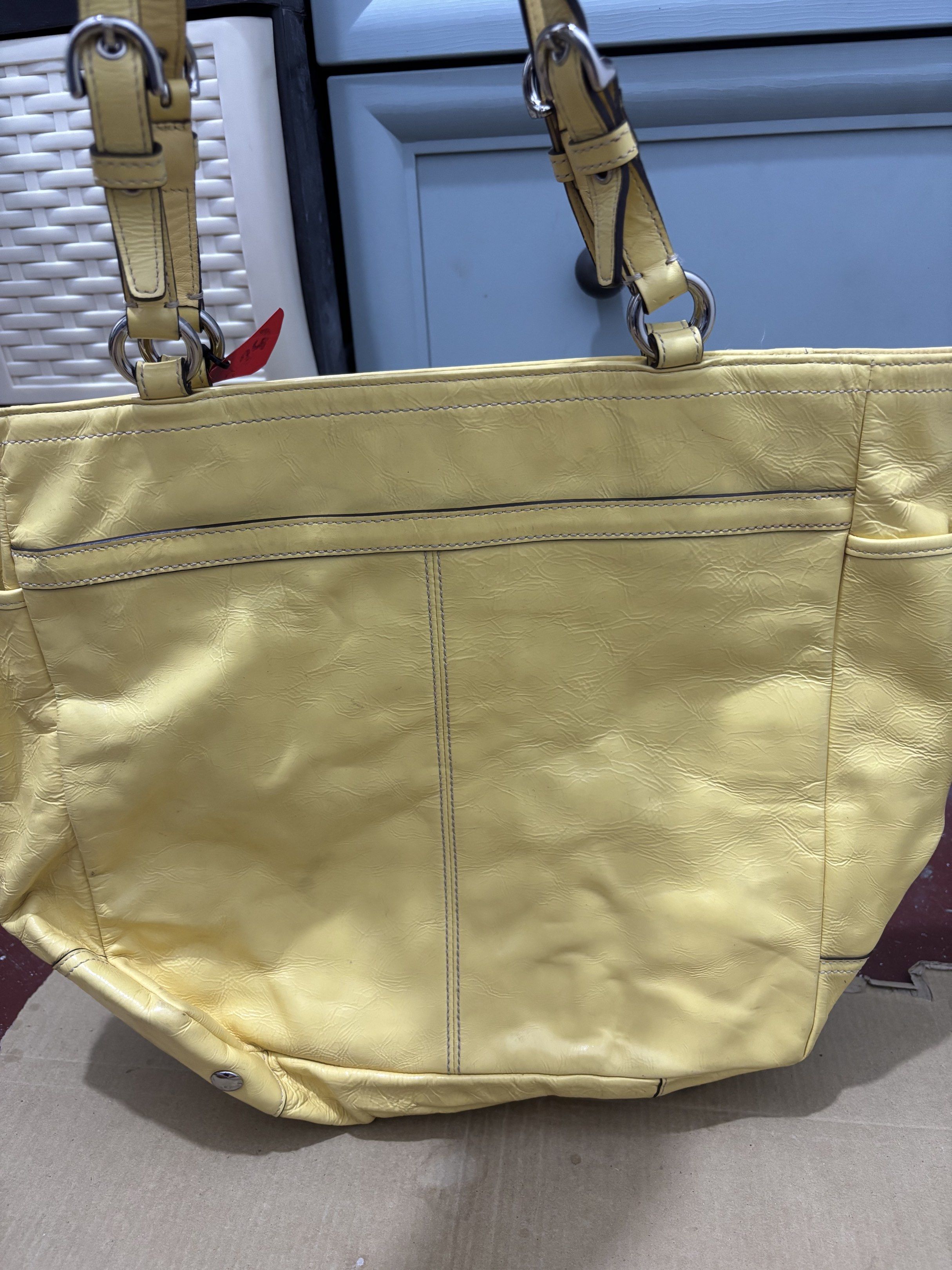 Coach Yellow Leather Tote Bag (Category: Shoulder Bags) located in Taguig. Submitted by macxdinglas (Listing ID 1422566290, Image 3). Description: - Yellow Coach tote bag - Main compartment with zipper closure - Interior pocket - Two exterior side pockets - Embossed Coach logo - Double handles - Silver-tone hardware - Authentic Coach Naka ykk mga zipper Padala ng sister ko from US malinis loob walang sira.