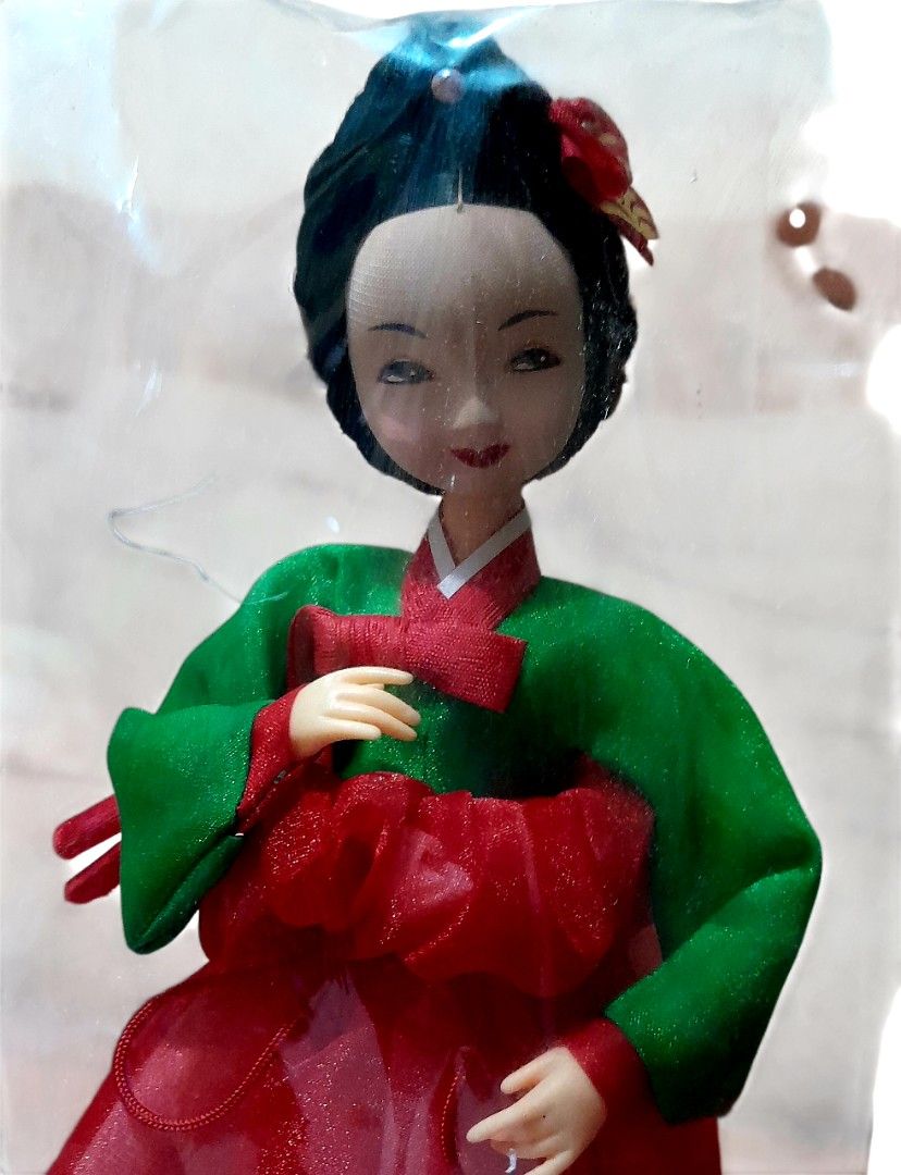 Collectible Korean Hanbok Doll (Category: Vintage Collectibles) located in Mandaluyong City. Submitted by twixie94147 (Listing ID 1422627317, Image 2). Description: - A traditional doll figurine dressed in a Hanbok, the traditional Korean costume. - Features a green top (jeogori) and a red skirt (chima). - Often used as a decorative ornament for desks, shelves, or as a souvenir. - Origin: The text "許氏工具" on the base suggests it may be a product f