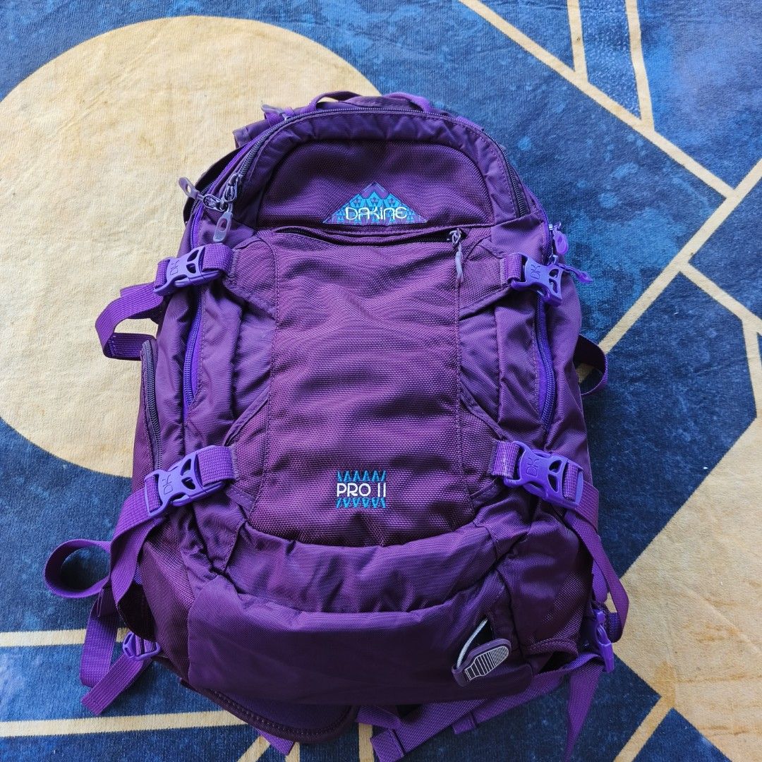 Dakine Urban Pro II Backpack - Purple (Category: Backpacks) located in Bayombong. Submitted by easyflip_04 (Listing ID 1422642119, Image 1). Description: - Dakine Urban Pro II backpack - Vibrant purple color - Multiple compartments for organization - Adjustable straps for a comfortable fit - Side pockets for easy access - Dakine logo on front and back - Secure storage with buckles and zippers.