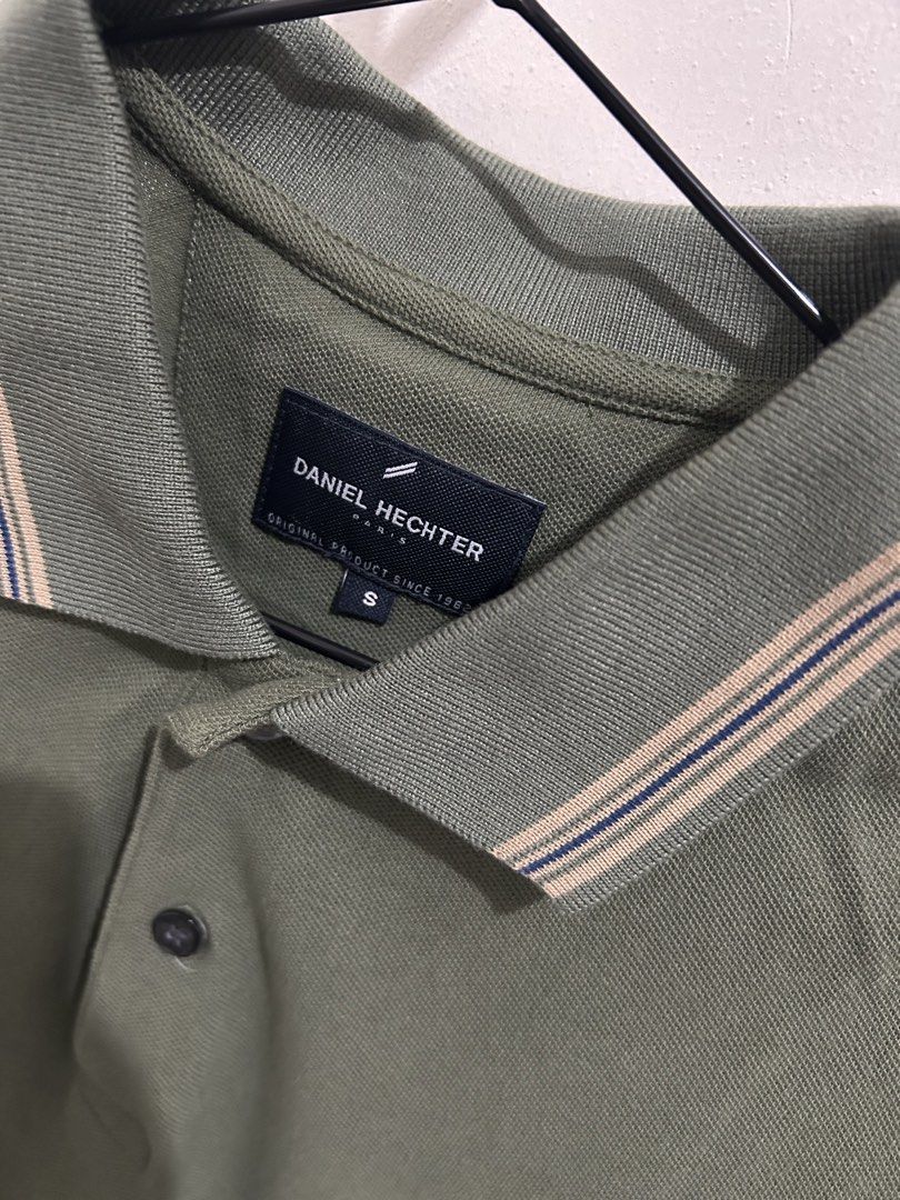 Daniel Hechter Polo Shirt - Olive Green (Category: Tshirts & Polo Shirts ) located in Mandaluyong City. Submitted by ncooooooo (Listing ID 1422634826, Image 2). Description: Daniel Hechter polo shirt Best for Small to Medium W: 18.5” L: 26.5” - Olive green color - Classic collar with striped details - Short sleeves with striped cuffs - Small logo on chest - Button-up placket - Comfortable fabric - Ideal for casual wear.