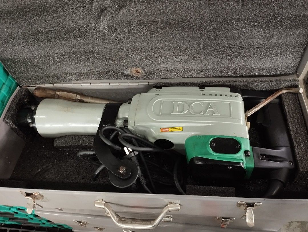 DCA Percussion Hammer (Category: Construction Tools & Equipment) located in Caloocan City. Submitted by dhiony (Listing ID 1422576972, Image 1). Description: - DCA demolition hammer - Original case included - Color: Green and gray - Features a handle and chisel - Easy to carry case - In good working condition.