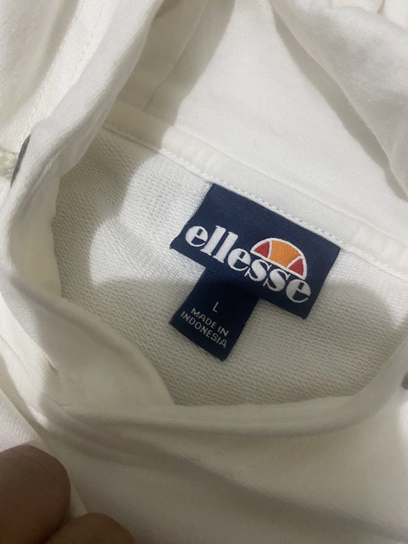 Ellesse White Hoodie (Category: Hoodies) located in Manila. Submitted by decluttering14 (Listing ID 1422556288, Image 3). Description: - Ellesse hoodie - Size: L - Features: Grey stripe across chest and sleeves, Ellesse logo - Made in: Indonesia - Material: 100% cotton.