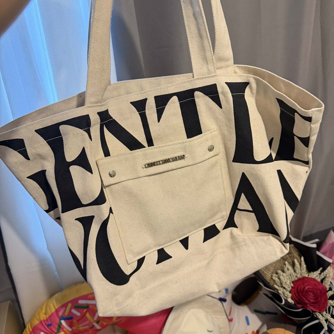 Gentlewoman Tote Bag (Category: Tote Bags) located in Manila. Submitted by perlitas (Listing ID 1422545161, Image 1). Description: Gentlewoman tote bag in cream color. Features a front pocket and the brand name printed on the front. The bag has a spacious interior and sturdy handles. The back of the bag has the brand name printed. Perfect for everyday use..