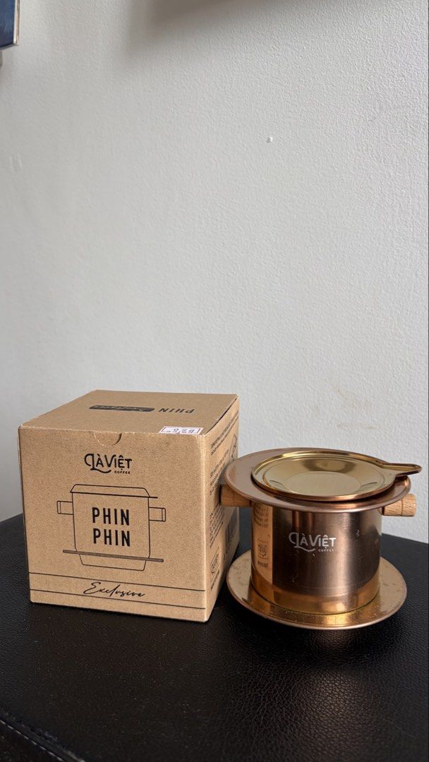 Gia Viet Phin Coffee Filter (Category: Coffee & Tea Tableware) located in Manila. Submitted by samgubaton (Listing ID 1422596968, Image 1). Description: - Authentic Gia Viet Phin coffee filter - Comes with original box - Made of durable copper - Includes a lid - Box is printed with "Phin Phin" - Exclusive and rare item.