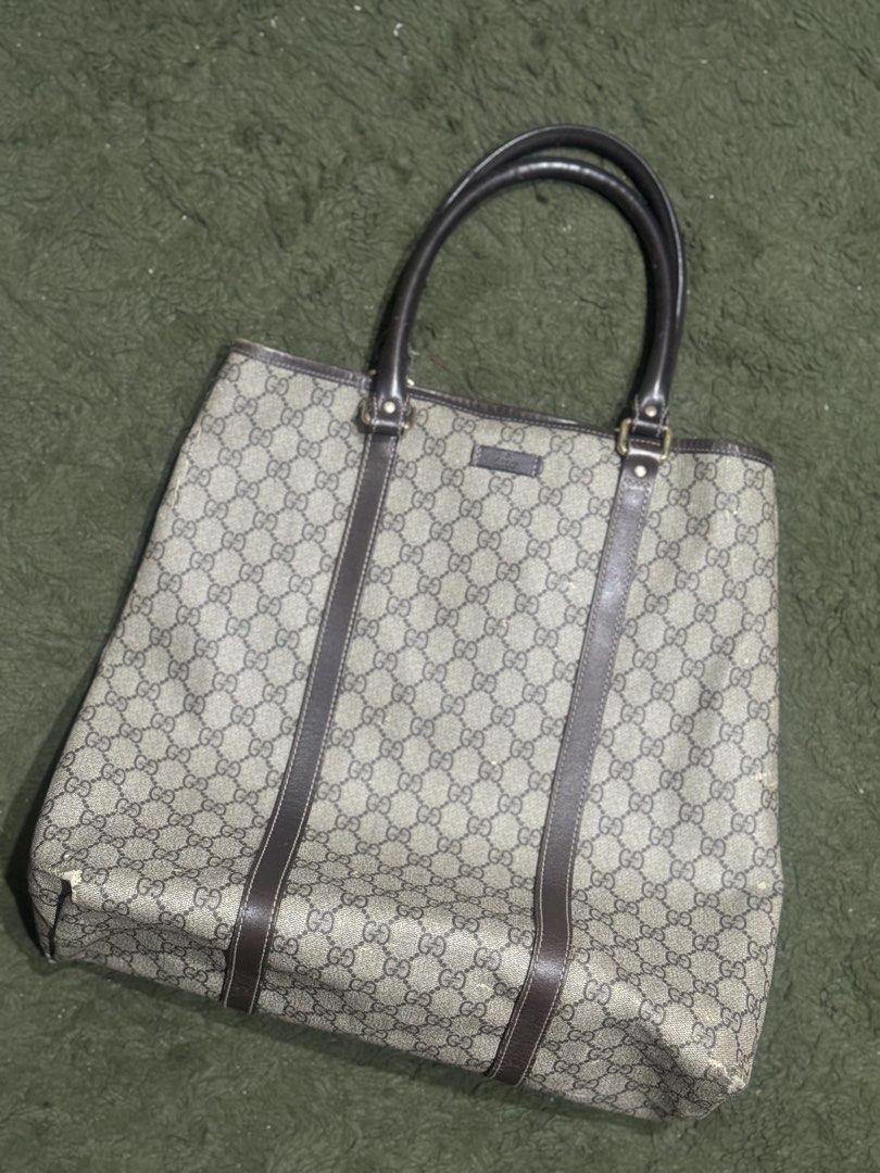 Gucci GG Supreme Tote Bag (Category: Luxury Bags & Wallets) located in Quezon City. Submitted by roxeyfoxey (Listing ID 1422576782, Image 1). Description: - Authentic Gucci tote bag - Iconic GG Supreme canvas - Brown leather handles and trim - Light-colored fabric interior - Signs of wear: marks on exterior, wear on handles - 7/10 arte rating.