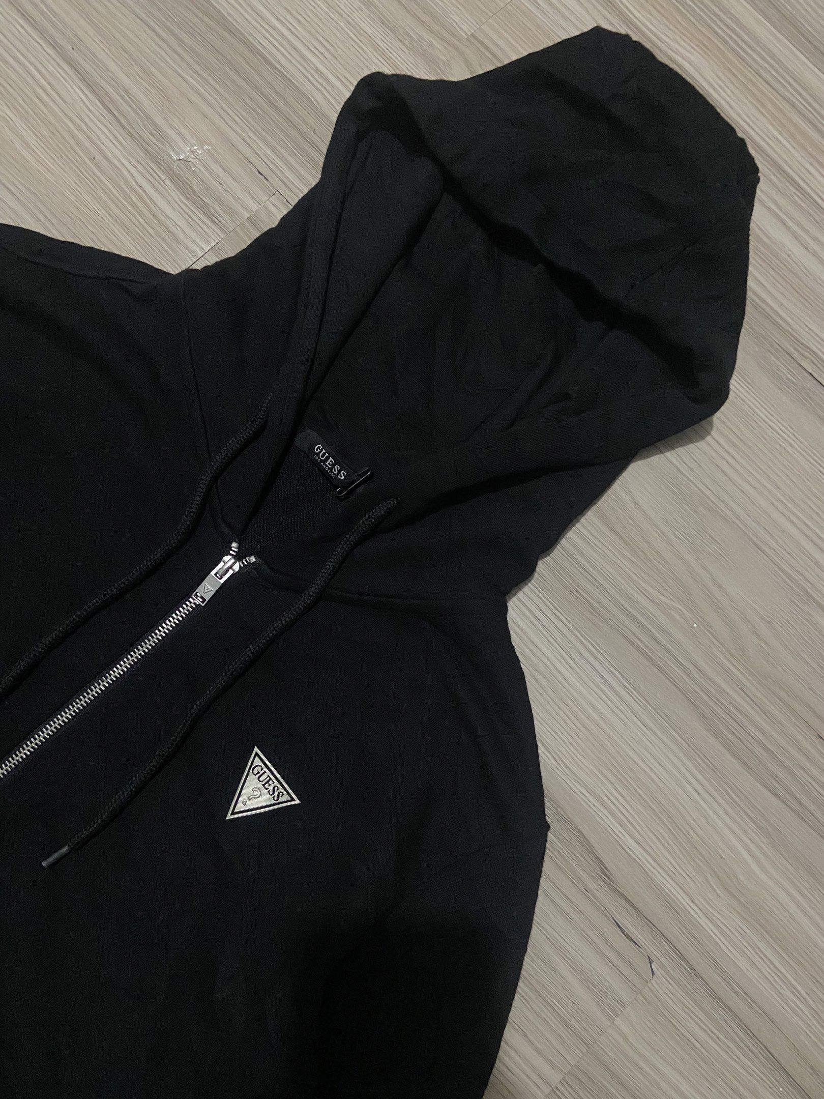 Guess Black Zip-Up Hoodie (Category: Hoodies) located in Cebu City. Submitted by charlyx (Listing ID 1422707305, Image 2). Description: - Black Guess zip-up hoodie - Size: 175/96A - Material: 65% cotton, 35% polyester - Features Guess logo - Drawstring hood - Ribbed cuffs and hem.