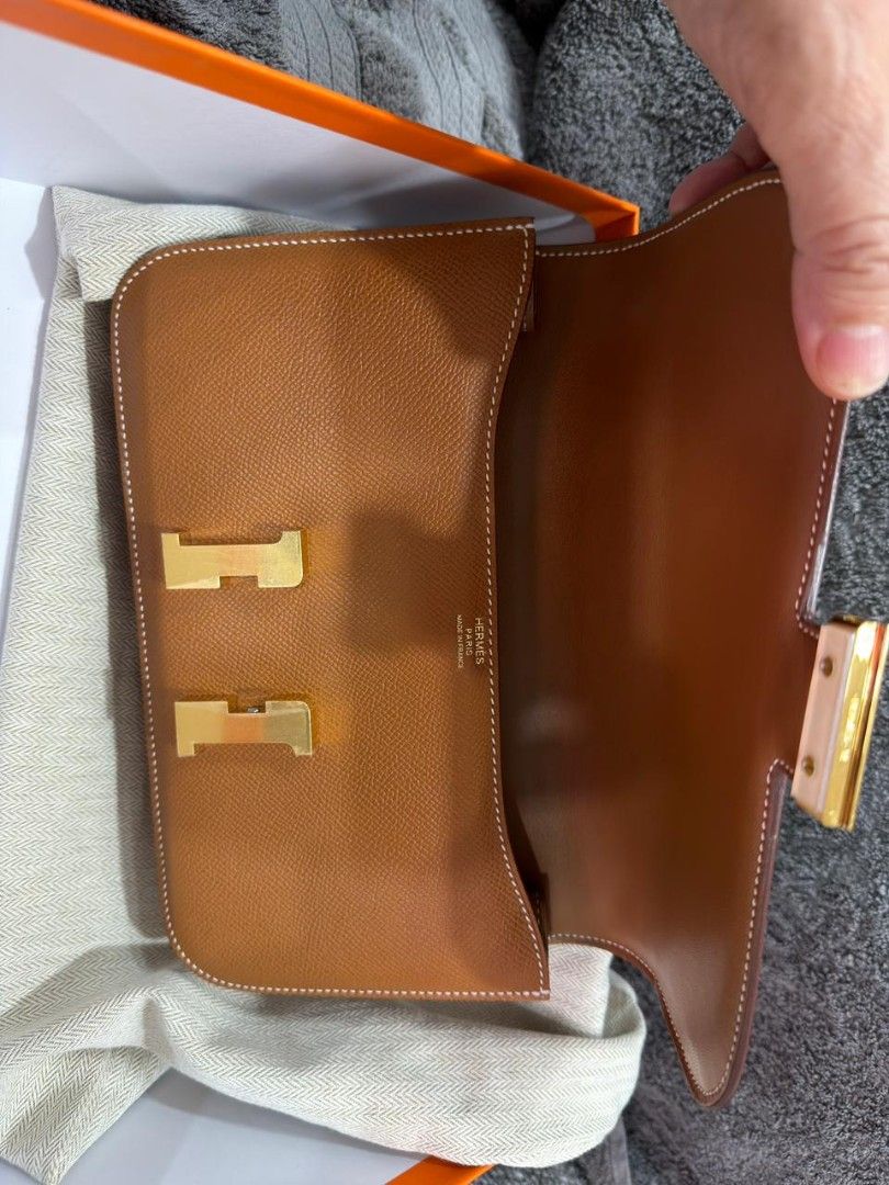 Hermes Constance Elan (Category: Luxury Bags & Wallets) located in Taguig. Submitted by amazingjyc (Listing ID 1422636650, Image 2). Description: - Authentic Hermes Constance Elan bag - Color: Brown - Features gold-tone H clasp - Includes leather shoulder strap - Interior with two compartments - Comes with original box, dust bag, and tag - Serial number visible - Elegant and classic design.