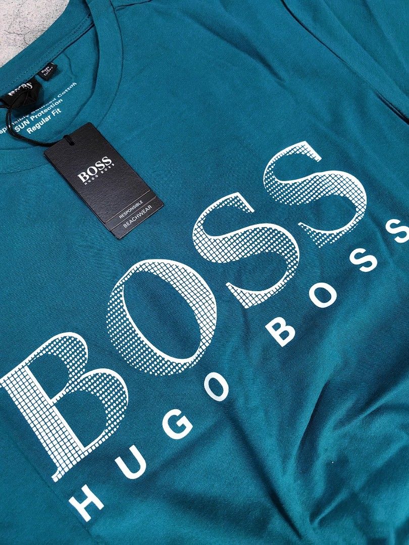 Hugo Boss BOSS T-shirt (Category: Tshirts & Polo Shirts ) located in Quezon City. Submitted by 110collectionsph (Listing ID 1422631329, Image 2). Description: PAMIGAY PRESYO NEW DROP ‼️ STEAL PRICE B0SS REGULAR FIT T-SHIRT | SMALL ONLY | P2,888 - Brand: Hugo Boss - Color: Teal - Design: BOSS logo print on front - Neckline: Crew neck - Sleeves: Short sleeves - Fit: Regular fit - Condition: New with original tags.
