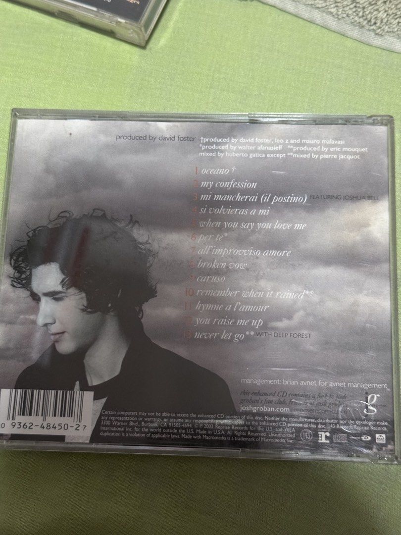 Josh Groban Self-Titled Album CD (Category: CDs & DVDs) located in Pasig City. Submitted by itsmejaypee25 (Listing ID 1422692190, Image 2). Description: CD album by Josh Groban. The album includes songs like "Oceano", "Mi Mancherai (Il Postino)", and "Caruso". It features Joshua Bell. The CD is produced by David Foster, Leo Z, and Mauro Malavasi. The back of the CD case lists the tracklist and production credits. The album is in its original case