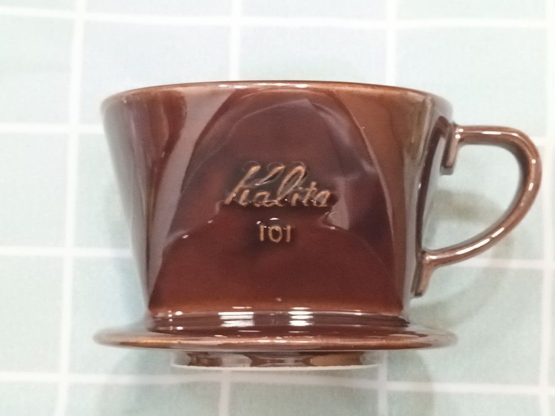 Kalita 101 Ceramic Coffee Dripper (Category: Coffee & Tea Tableware) located in Calamba. Submitted by m_brian (Listing ID 1422655710, Image 2). Description: - Kalita 101 ceramic coffee dripper - Brown color - Features Kalita logo and model number - Interior ridges for optimal brewing.