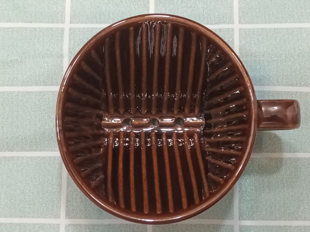 Kalita 101 Ceramic Coffee Dripper (Category: Coffee & Tea Tableware) located in Calamba. Submitted by m_brian (Listing ID 1422655710, Image 3). Description: - Kalita 101 ceramic coffee dripper - Brown color - Features Kalita logo and model number - Interior ridges for optimal brewing.
