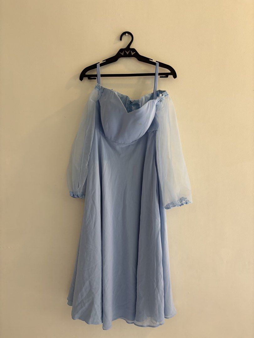 Light Blue Tea Length Gown (Category: Dresses) located in Makati City. Submitted by harekrisha (Listing ID 1422560411, Image 2). Description: Worn once for a special event when I was one year postpartum (size Medium). This dress features an elegant off-shoulder design with a sweetheart neckline, sheer bishop sleeves, and a flattering A-line tea-length skirt. Made from smooth, flowing formal fabric in a soft blue shade. Originally paid ₱8,000. The