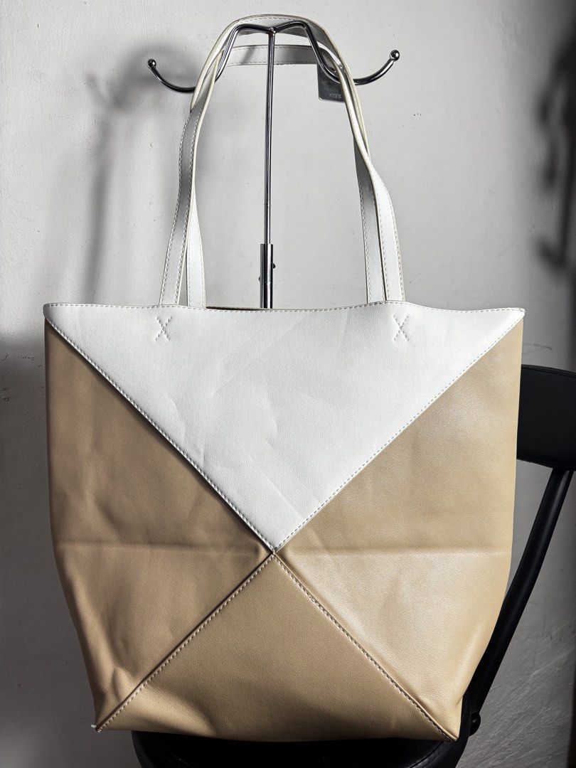 Loewe Puzzel Fold Tote Bag (Category: Luxury Bags & Wallets) located in Caloocan City. Submitted by thrift.crcl (Listing ID 1422600218, Image 2). Description: The item shown is a LOEWE Puzzle Fold tote bag, which features a distinctive geometric panelled design inspired by the classic Puzzle bag Good condition Size medium Sign of usage in sling check pictures.