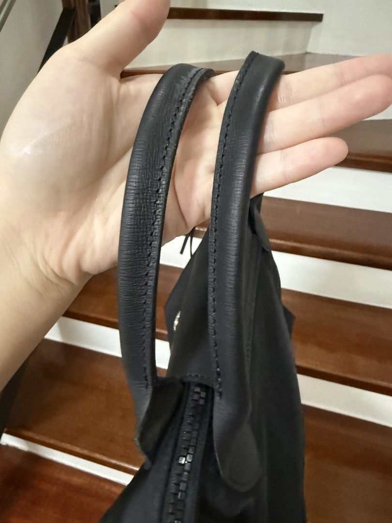 Longchamp Le Pliage with Strap (Category: Luxury Bags & Wallets) located in Cavite. Submitted by cha____r (Listing ID 1422627127, Image 3). Description: Authentic Longchamp Le Pliage Cuir handbag Black Used condition See photos for flaws.