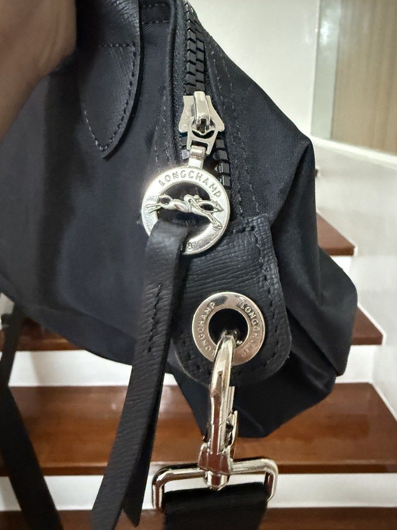 Longchamp Le Pliage with Strap (Category: Luxury Bags & Wallets) located in Cavite. Submitted by cha____r (Listing ID 1422627127, Image 2). Description: Authentic Longchamp Le Pliage Cuir handbag Black Used condition See photos for flaws.