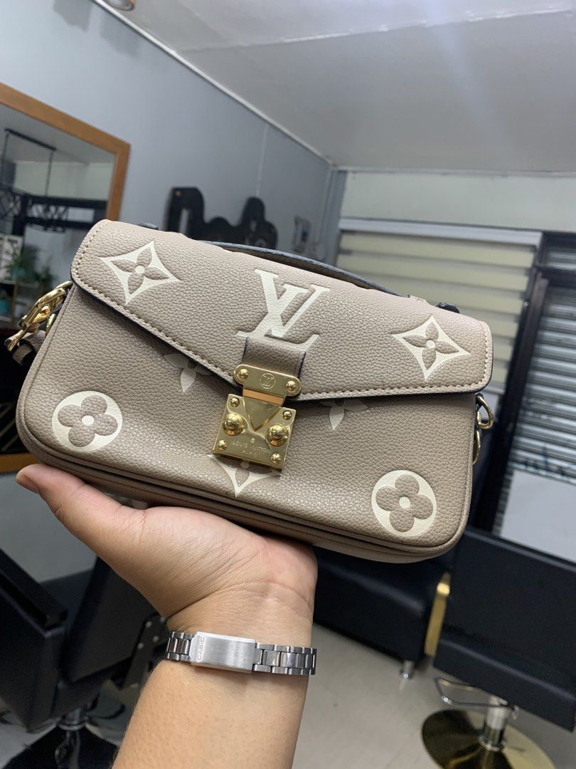 Louis Vuitton Coussin PM Bag (Category: Luxury Bags & Wallets) located in San Jose. Submitted by pillowieone (Listing ID 1422670687, Image 2). Description: Louis Vuitton Coussin PM bag features a beige color with white floral and LV logo details. It has a gold-tone chain strap and hardware. The bag has a zip closure and a small pocket inside. The bag has a leather exterior and a fabric interior. The bag has a top handle and a shoulder strap..
