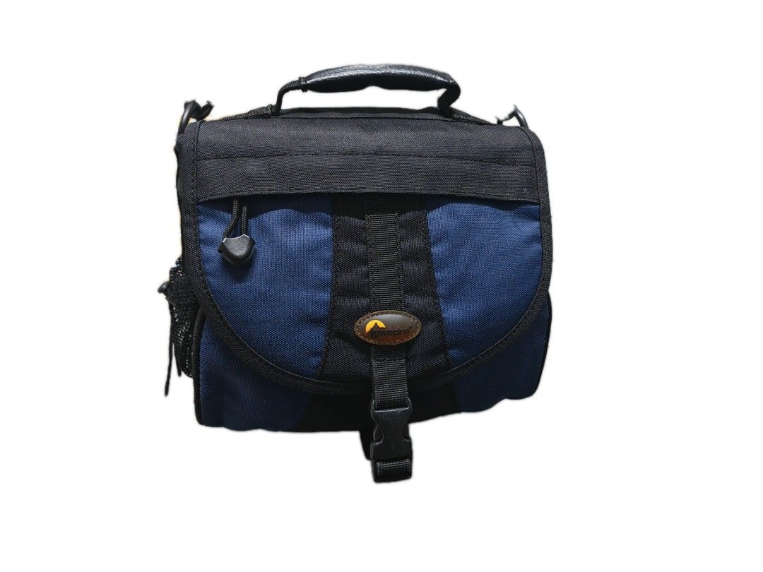 Lowepro EX 160 Camera Bag (Category: Camera Bags & Carriers) located in Pasig City. Submitted by she_declutters_ph (Listing ID 1422683738, Image 2). Description: RFS: Decluttering Issue: Missing 1 divider, see Pic 4 . Needs washing. Lowepro EX 160 camera bag features a black and blue color scheme. It has a top handle and a detachable shoulder strap. The bag has a main compartment with a padded divider and several pockets. It also has side mesh po