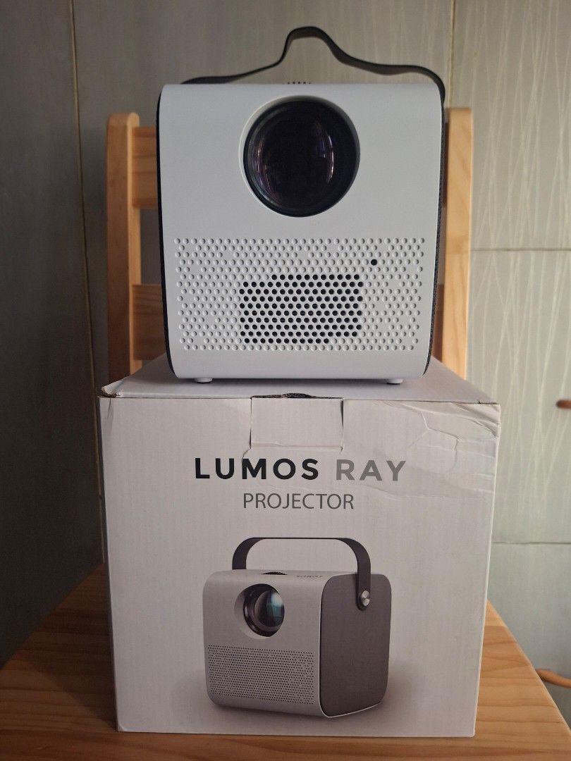 Lumos Ray Projector (Category: Projectors) located in Pasay City. Submitted by jkmv0211 (Listing ID 1422554746, Image 1). Description: - Lumos Ray projector with multiple ports (HDMI, USB, AV). - Comes with remote control, power cable, and AV cable. - Features focus adjustment. - Built-in handle for easy portability. - Includes original box and user manual. Cash or Gcash Will give it for 8,000 if willing to meet up at Metropoint Mall Pasay..