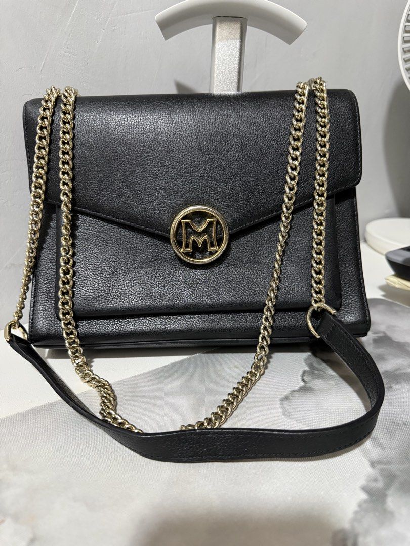 Metrocity convertible Sling and Shoulder Chain Bag (Category: Shoulder Bags) located in Antipolo. Submitted by lelaimanz (Listing ID 1422553814, Image 1). Description: - Original Metrocity Black shoulder/sling convertible bag - Gold chain strap - 'M' logo on flap closure - Back zippered pocket - Interior compartment - Structured shape - Cowhide Leather material - Wear as shoulder bag or crossbody - Size height 7" x Width 9" ❗️ flaw: - visible fad