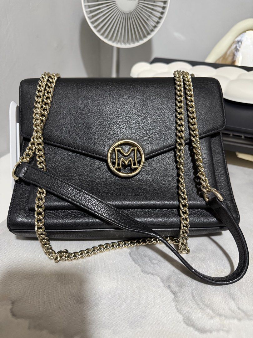 Metrocity convertible Sling and Shoulder Chain Bag (Category: Shoulder Bags) located in Antipolo. Submitted by lelaimanz (Listing ID 1422553814, Image 2). Description: - Original Metrocity Black shoulder/sling convertible bag - Gold chain strap - 'M' logo on flap closure - Back zippered pocket - Interior compartment - Structured shape - Cowhide Leather material - Wear as shoulder bag or crossbody - Size height 7" x Width 9" ❗️ flaw: - visible fad