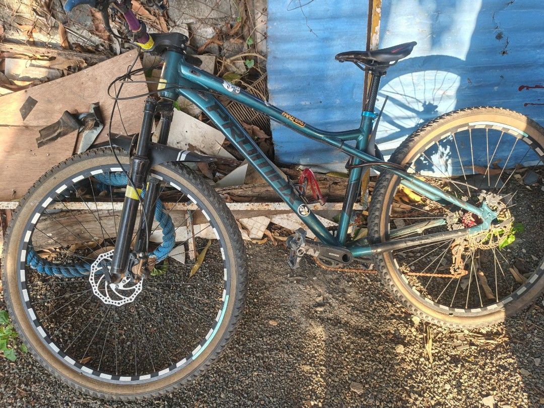Promax Mountain Bike (Category: Bicycles) located in Binan City. Submitted by designconstruct (Listing ID 1422625673, Image 1). Description: - Mountain Peak mountain bike - Disc brakes - Teal frame - Black suspension fork - Tan-walled tires - Black seat - Visible gear system - In good working condition - Ready for trails.