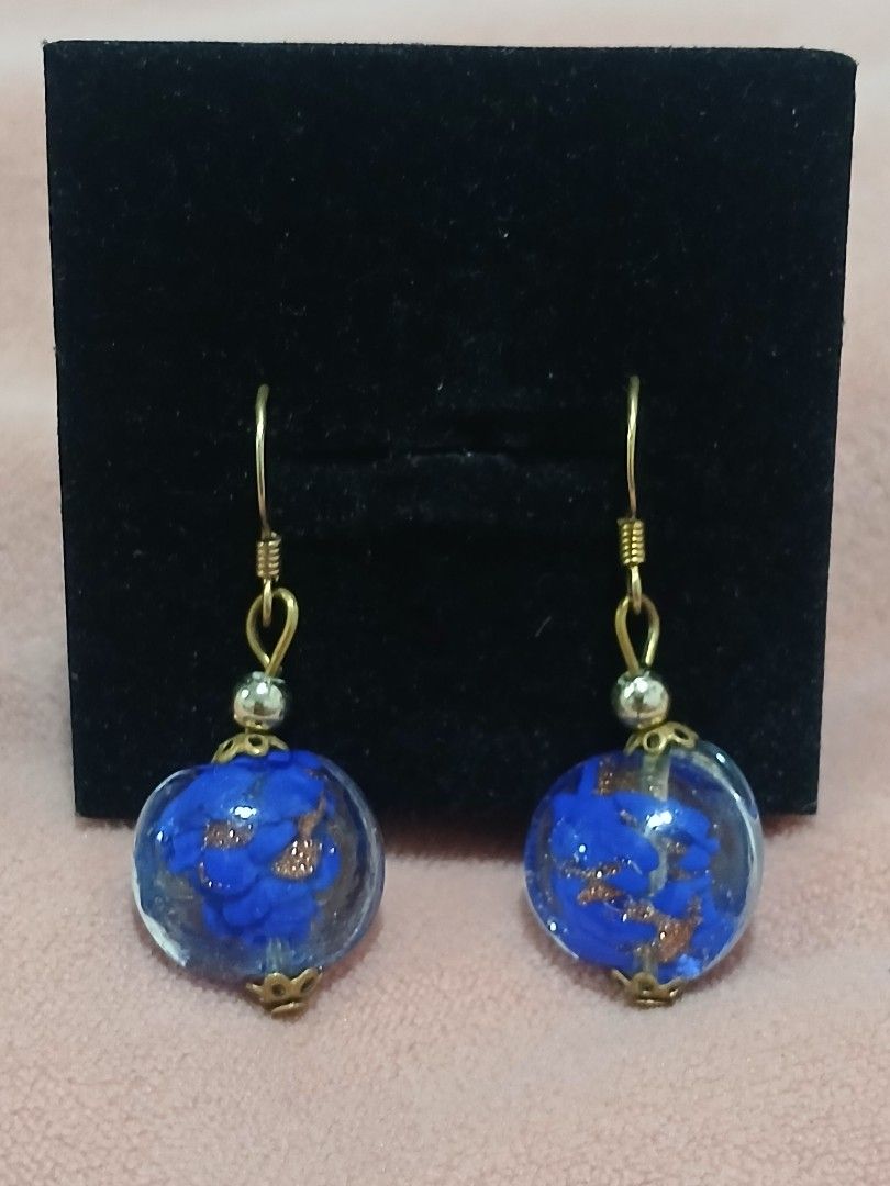 Murano Glass Blue & Gold Foil Dangle Earrings (Category: Earrings) located in Sariaya. Submitted by cuatrocats (Listing ID 1422684849, Image 3). Description: - Beautifully handcrafted Murano glass earrings - Features a vibrant cobalt blue base infused with shimmering copper/gold aventurine flecks - Elegant drop style with gold-tone French hooks.