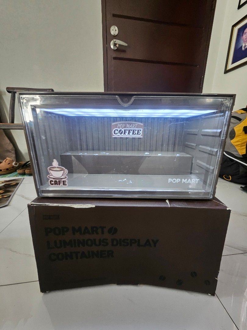 Pop Mart Luminous Display Container (Category: Storage Boxes & Baskets) located in Manila. Submitted by declutterhopper (Listing ID 1422612098, Image 2). Description: - Pop Mart Luminous Display Container - Coffee Shop Theme - Features a built-in light - Comes with original box - Designed for collectibles - Clear front panel for easy viewing.