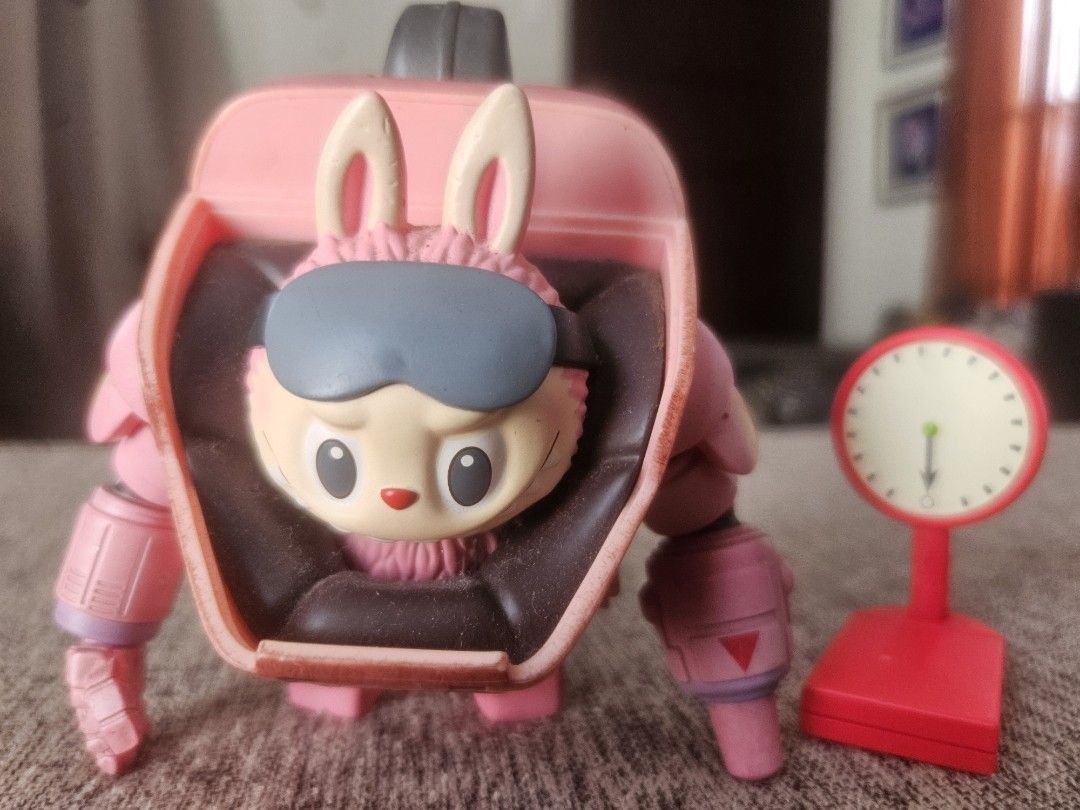 Pop Mart x Kasing Bunny Robot Figure (Category: Designer & Blind Box Toys) located in Manila. Submitted by declutterhopper (Listing ID 1422611717, Image 1). Description: - Pink bunny robot collectible figure - Includes matching red scale - Detailed design with bunny face and robot body - Features Pop Mart logo and model information - Ideal for collectors.