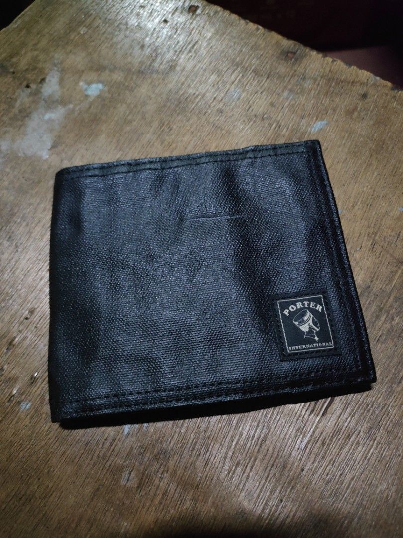 Porter International Black Wallet (Category: Wallets & Card Holders) located in Quezon City. Submitted by markythegrappler17 (Listing ID 1422690627, Image 1). Description: - Black Porter International wallet - Multiple card slots (8) - Bill compartment - Elastic band closure - Porter International logo visible - Made of durable, textured material.