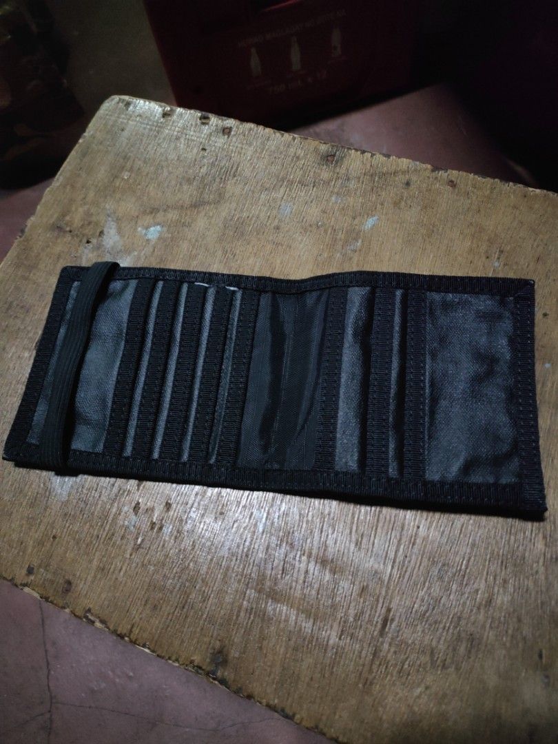 Porter International Black Wallet (Category: Wallets & Card Holders) located in Quezon City. Submitted by markythegrappler17 (Listing ID 1422690627, Image 3). Description: - Black Porter International wallet - Multiple card slots (8) - Bill compartment - Elastic band closure - Porter International logo visible - Made of durable, textured material.