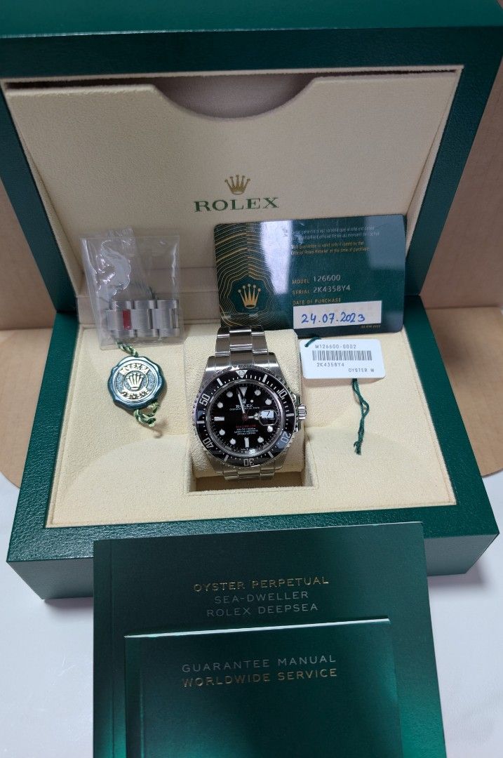 Rolex Sea Dweller 126600-0002 (Category: Watches) located in Singapore. Submitted by zronigel (Listing ID 1422635523, Image 1). Description: - Authentic Rolex Sea Dweller 126600-0002 - Includes original box, manual, booklet, warranty card, green & white tag. - Comes with extra links. - Features a sleek black dial. - Stainless steel bracelet. - Watch Armour protection film applied. - Warranty dated July 2023. - Without the watch box outer sleeve. 