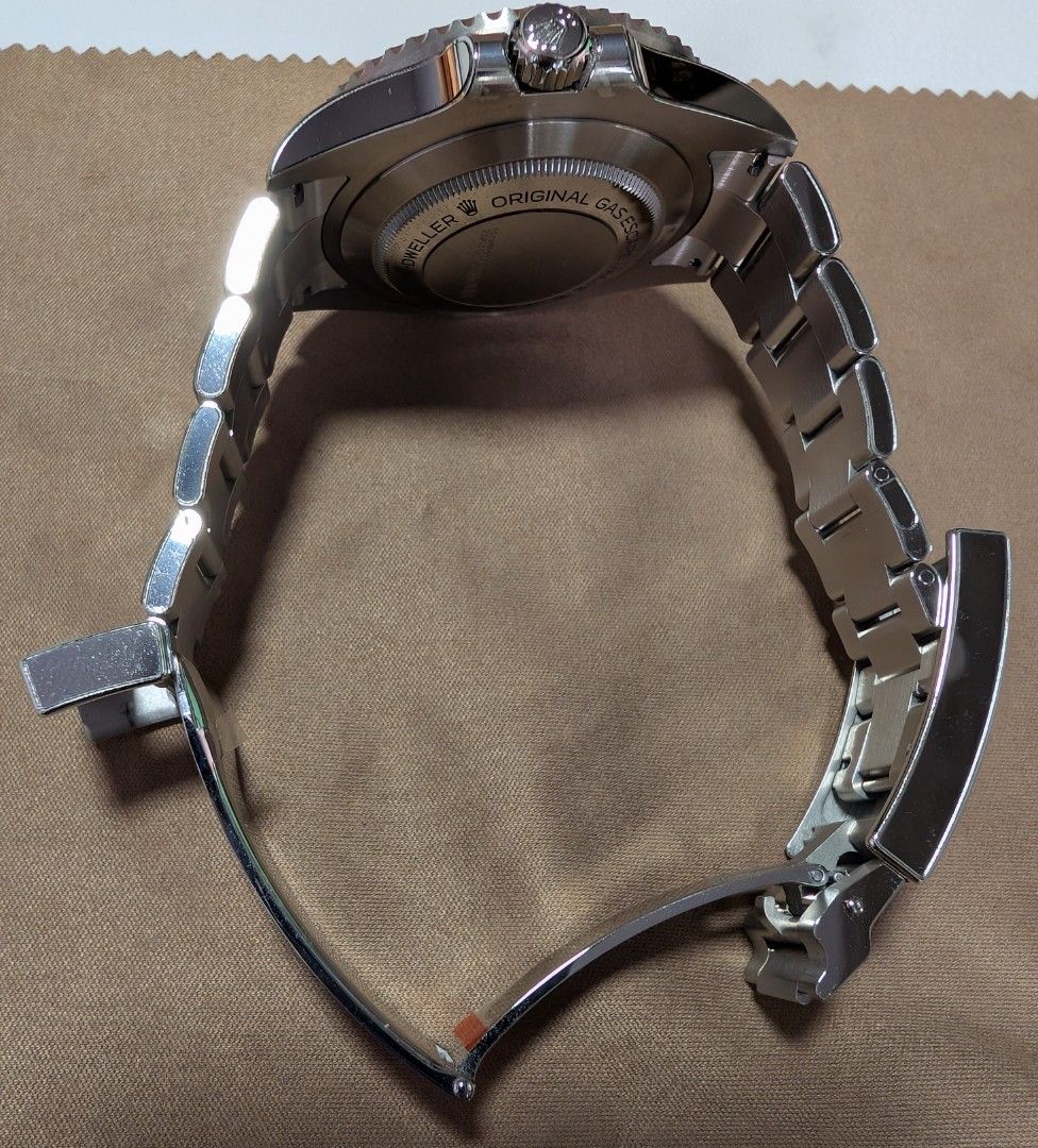 Rolex Sea Dweller 126600-0002 (Category: Watches) located in Singapore. Submitted by zronigel (Listing ID 1422635523, Image 3). Description: - Authentic Rolex Sea Dweller 126600-0002 - Includes original box, manual, booklet, warranty card, green & white tag. - Comes with extra links. - Features a sleek black dial. - Stainless steel bracelet. - Watch Armour protection film applied. - Warranty dated July 2023. - Without the watch box outer sleeve. 