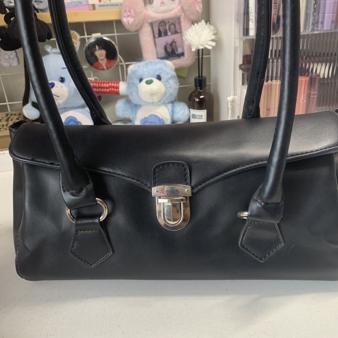 Shoulder Bag (Category: Shoulder Bags) located in Quezon City. Submitted by breadjinniecheeks (Listing ID 1422640957, Image 1). Description: - Black rectangular shoulder bag - Silver clasp closure - Two handles - Back zippered pocket - Spacious interior - Dimensions: 11.5" length, 6" height, 10" handle drop - From Korea - Never used! Stored after buying.
