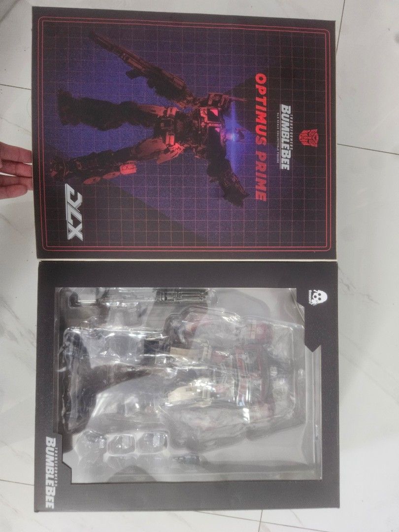 Threezero Transformers Bumblebee DLX Optimus Prime (Category: Figurines & Statues) located in Manila. Submitted by declutterhopper (Listing ID 1422608899, Image 3). Description: - Threezero DLX Optimus Prime collectible figure. - From the Transformers Bumblebee movie. - Includes multiple interchangeable hands. - Comes with a blaster and stand. - Highly detailed and articulated. - In original packaging..