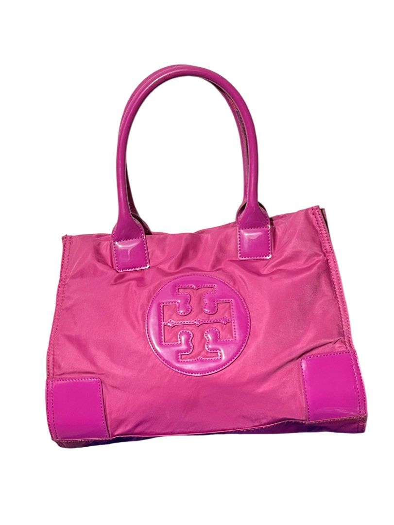 Tory Burch Pink Tote Bag (Category: Luxury Bags & Wallets) located in Paranaque City. Submitted by kyriaki_thrift_shop (Listing ID 1422161551, Image 1). Description: - Tory Burch tote bag - Eye-catching pink color with a glossy finish - Features two top handles - Prominent logo on the front - Interior includes multiple pockets for organization - Secure zipper closure - Constructed from a durable, nylon-like material.