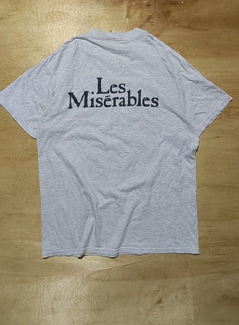 Vintage 90s Les Miserables Graphic Tee (Category: Tshirts & Polo Shirts ) located in Cagayan de Oro. Submitted by james_dig (Listing ID 1422610256, Image 2). Description: -30"x23" - Gray color (pinhole armpit area and minimal crack prints) -need wash - Les Miserables" text on the back - Great for fans of the musical or vintage tees.