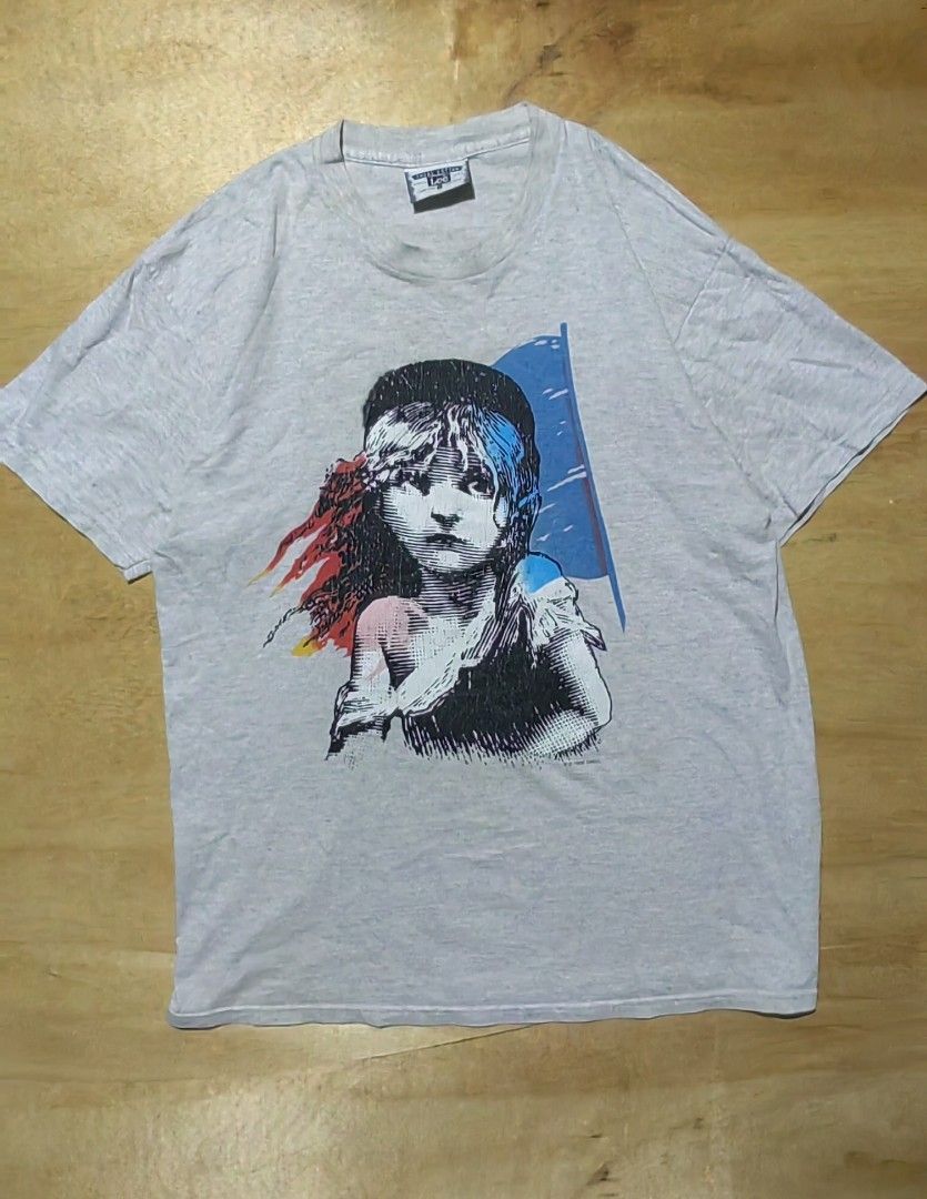Vintage 90s Les Miserables Graphic Tee (Category: Tshirts & Polo Shirts ) located in Cagayan de Oro. Submitted by james_dig (Listing ID 1422610256, Image 1). Description: -30"x23" - Gray color (pinhole armpit area and minimal crack prints) -need wash - Les Miserables" text on the back - Great for fans of the musical or vintage tees.