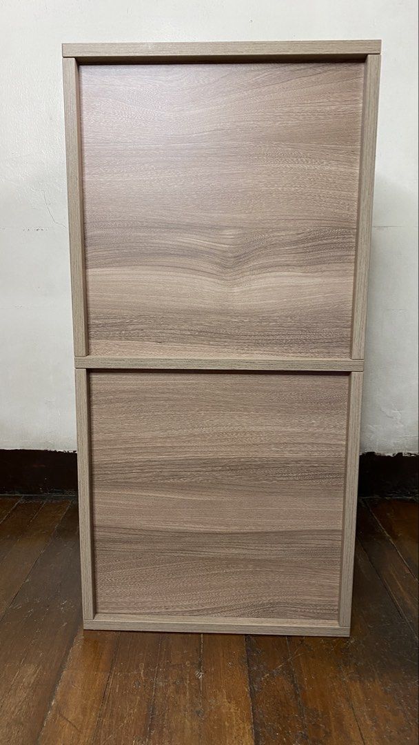 Wooden Cabinet with Drawers (Category: Shelves, Cabinets & Racks) located in Quezon City. Submitted by joannerc (Listing ID 1422548680, Image 3). Description: - Wooden cabinet - Two-door upper section - Two drawers below - Light wood grain finish - Modular design (top and bottom sections may separate) - Suitable for various rooms.