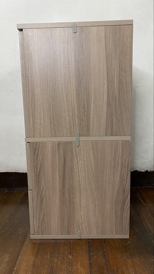 Wooden Cabinet with Drawers (Category: Shelves, Cabinets & Racks) located in Quezon City. Submitted by joannerc (Listing ID 1422548680, Image 2). Description: - Wooden cabinet - Two-door upper section - Two drawers below - Light wood grain finish - Modular design (top and bottom sections may separate) - Suitable for various rooms.