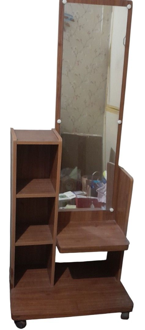 Wooden Dressing Table with Mirror (Category: Tables & Sets) located in Mandaluyong City. Submitted by twixie94147 (Listing ID 1422644466, Image 1). Description: - Wooden dressing table - Large rectangular mirror - Shelf unit with three shelves - Mobile on wheels - Warm brown wood finish.