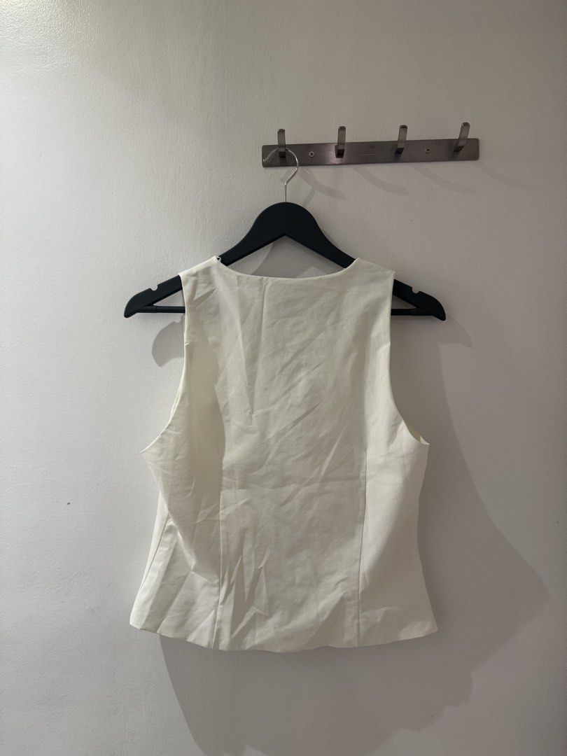 Zara Sleeveless Bow Vest Top (Category: Sleeveless) located in Manila. Submitted by bridgetdrdo (Listing ID 1422595506, Image 3). Description: - Ribboned Top - Dirty White - Perfect for dressing up or dressing down!.