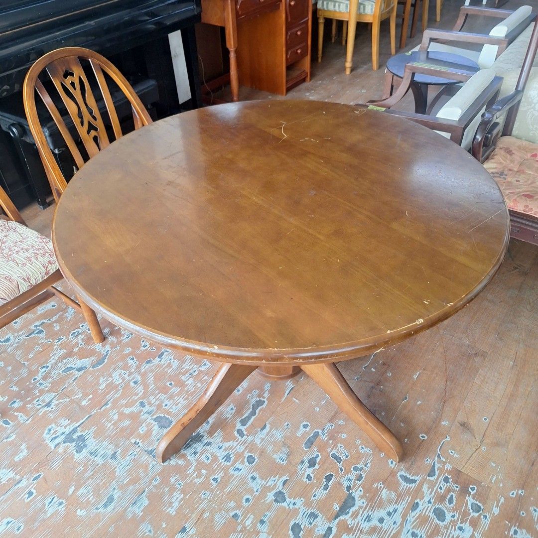 2nd hand Pedestal Round Wooden Dining Table (Category: Tables & Sets) located in Paranaque City. Submitted by 2ndcharmfurniture (Listing ID 1422741148, Image 2). Description: Round wooden dining table with a pedestal base. The table has a dark brown finish. Dimensions are D106cm and H71cm. It is suitable for a dining area or kitchen. The table is sturdy and can accommodate multiple diners. It is a classic design that will complement various inter