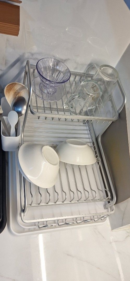 2-Tier Dish Rack (Category: Food Organization & Storage) located in Makati City. Submitted by r_lopez (Listing ID 1422785670, Image 3). Description: 2-tier dish rack is perfect for organizing your dishes and cutlery. It has a tray to catch water and a separate compartment for utensils. The rack is made of metal and plastic. It's a great space-saving solution for your kitchen. It can hold plates, bowls, cups, and glasses..