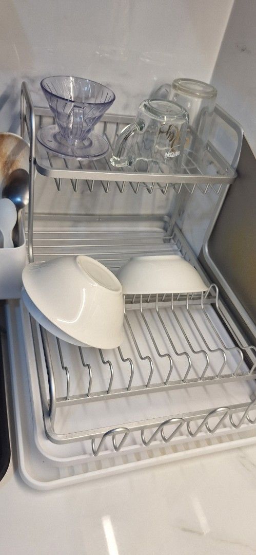 2-Tier Dish Rack (Category: Food Organization & Storage) located in Makati City. Submitted by r_lopez (Listing ID 1422785670, Image 1). Description: 2-tier dish rack is perfect for organizing your dishes and cutlery. It has a tray to catch water and a separate compartment for utensils. The rack is made of metal and plastic. It's a great space-saving solution for your kitchen. It can hold plates, bowls, cups, and glasses..