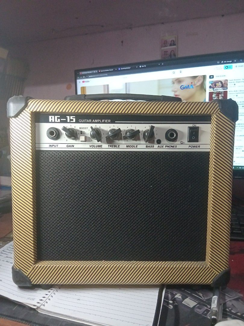 AG-15 Guitar Amplifier (Category: Musical Instruments) located in Paranaque City. Submitted by chechein_shop (Listing ID 1422812206, Image 1). Description: - AG-15 guitar amplifier - Input, Gain, Volume, Treble, Middle, Bass, and Phones controls - Power switch included - Black speaker cover - Tan-colored frame.