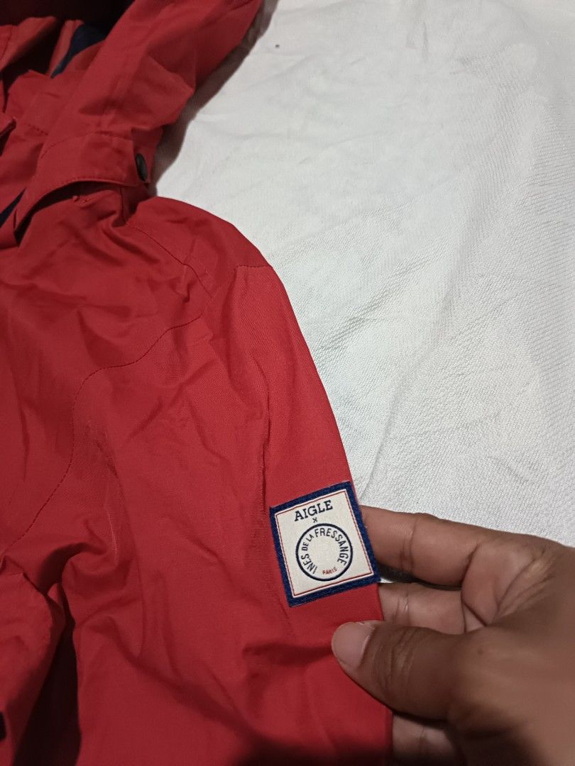 Aigle waterproof parka (Category: Coats, Jackets and Outerwear) located in Narra. Submitted by davidddyyy (Listing ID 1422903217, Image 3). Description: - Aigle red hooded jacket - Size: S - Features: - Drawstring waist - Hood - Small logo patch on sleeve - Full-length zipper - Two front pockets - Contrasting interior lining -580+sf.