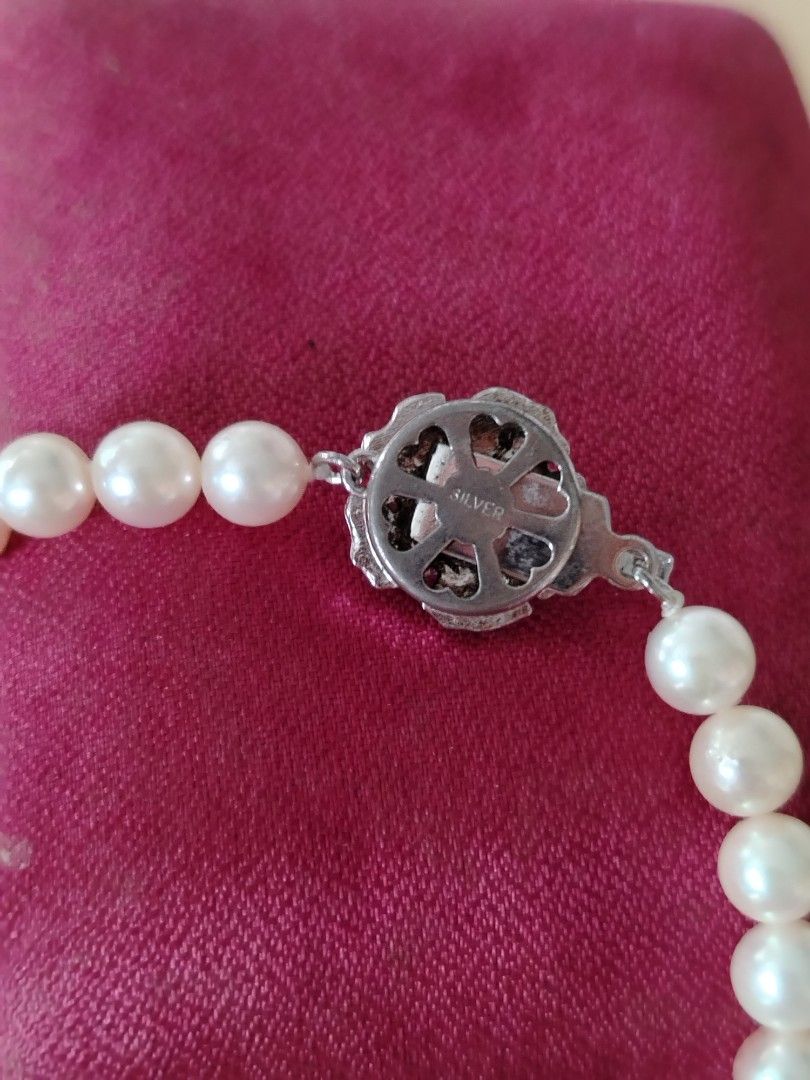 Akoya Pearl Necklace with Silver Clasp (Category: Necklaces) located in Tayasan. Submitted by _raceprettyconcept (Listing ID 1422742665, Image 2). Description: - real akoya pearl necklace from japan 18" -6mm - Features a silver clasp with floral design - Creamy white pearls - Comes with a red presentation box - Classic piece for any outfit.