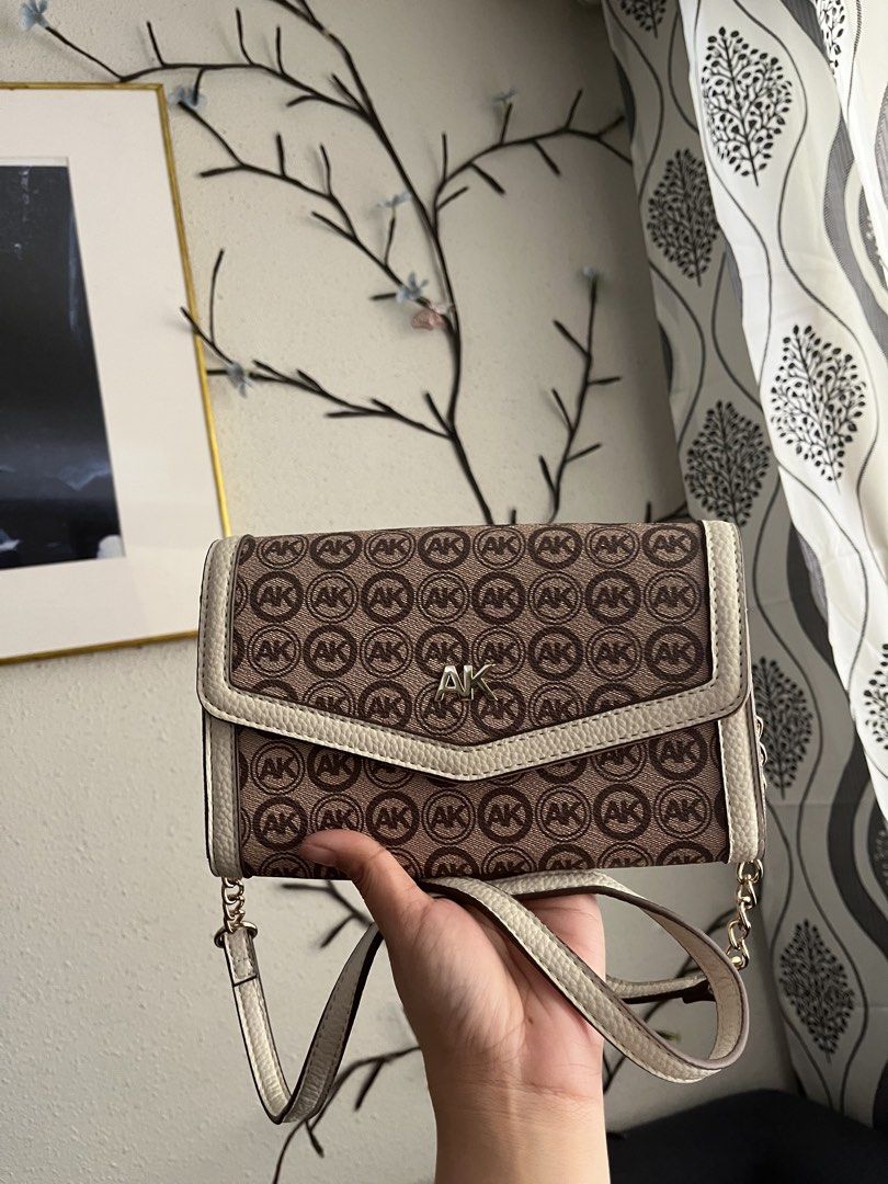 Anne Klein Logo Wallet on a Chain (Category: Luxury Bags & Wallets) located in Manila. Submitted by ronalynrey57532 (Listing ID 1422754007, Image 2). Description: - Anne Klein wallet on a chain - Brown and cream color scheme - Features the AK logo pattern - Detachable strap - Multiple interior compartments - Magnetic closure - Brand new with original tag - MSRP: $58.