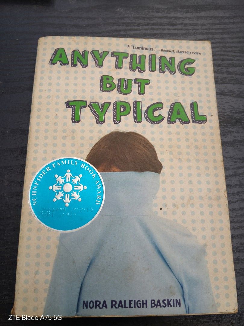 Anything But Typical by Nora Raleigh Baskin (Category: Storybooks) located in Quezon City. Submitted by ipasa.pagkabasa (Listing ID 1422744584, Image 1). Description: - Title: Anything But Typical - Author: Nora Raleigh Baskin - Features a Schneider Family Book Award sticker - Cover: Person in a blue shirt - Background: Light green and white polka dots.