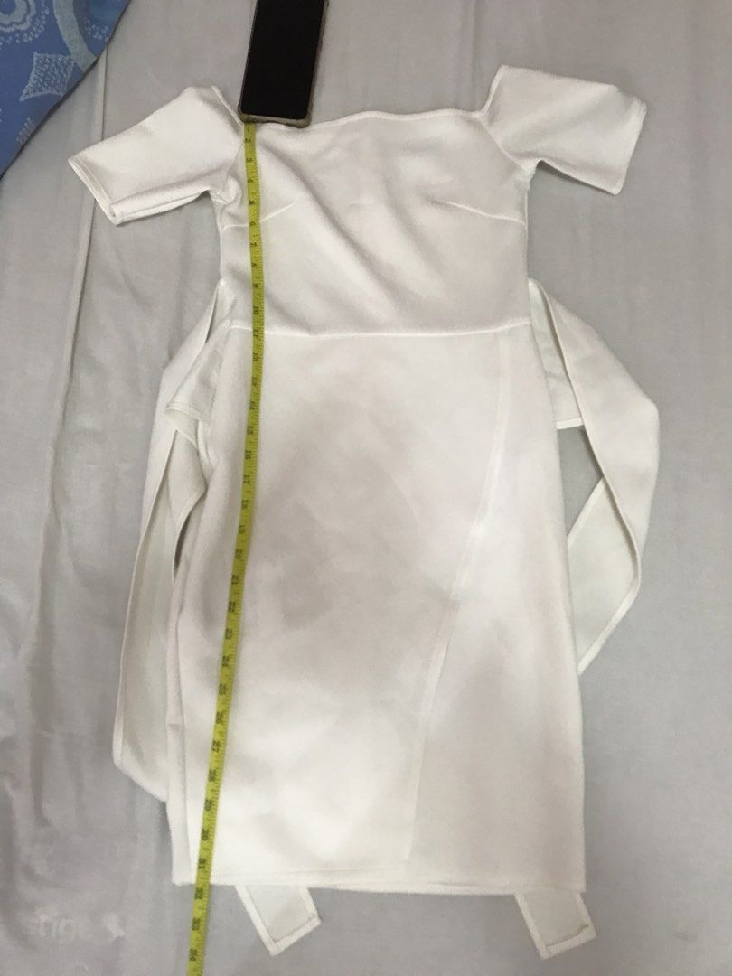 Apartment Eight Midi White Dress (Category: Dresses) located in Quezon City. Submitted by luckyvicky831 (Listing ID 1422793767, Image 2). Description: - Apartment Eight white dress - Size: M - Style: Off-shoulder with short sleeves - Closure: Back zipper - Skirt: Wrap style with attached waist tie - Material: Smooth, possibly satin-like.
